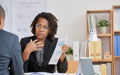 African-American business woman explaining results of her work to colleague