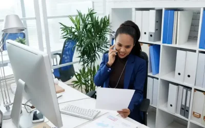 smiling-asian-woman-sitting-desk-office-looking-document-talking-mobile-phone-1024x683_11zon